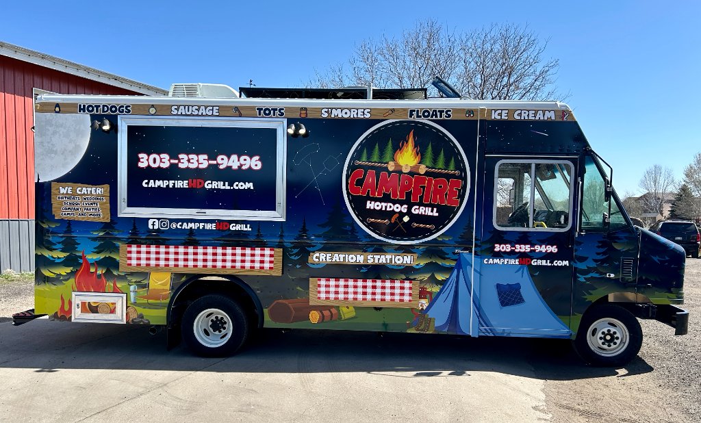 Campfire Hotdog Grill truck parked on a grassy event field.