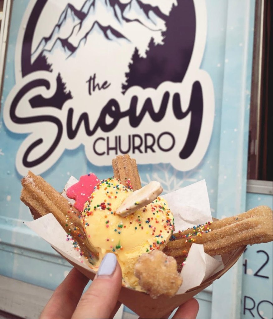 Neighbors gathered around The Snowy Churro truck at a community block party.