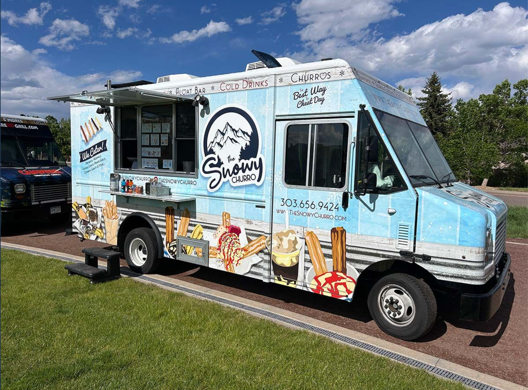 Colorful food truck offering churros and frozen treats.