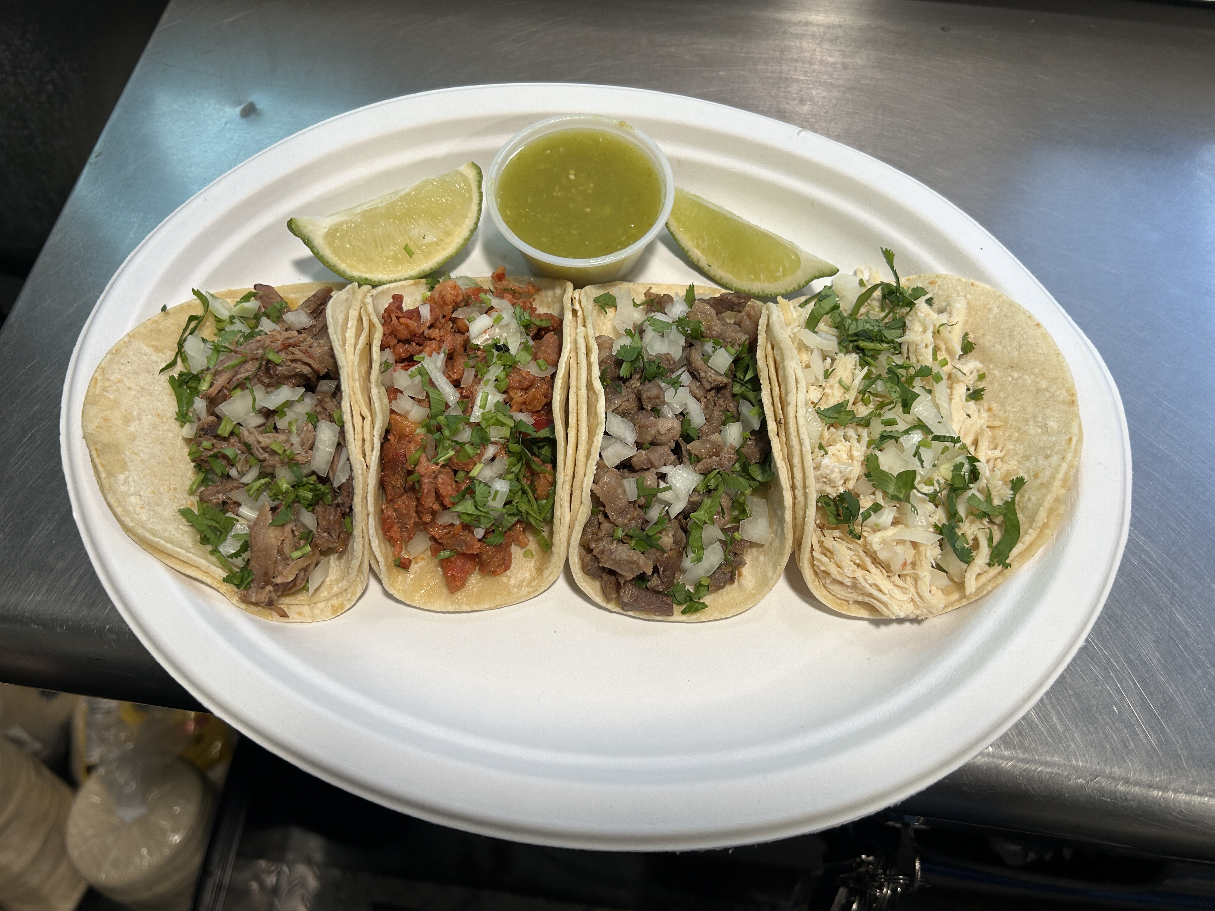 Delicious tacos featuring various meats garnished with fresh cilantro and onions.