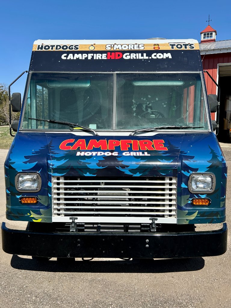 Side view of the Campfire Hotdog Grill truck with branded camping mural.