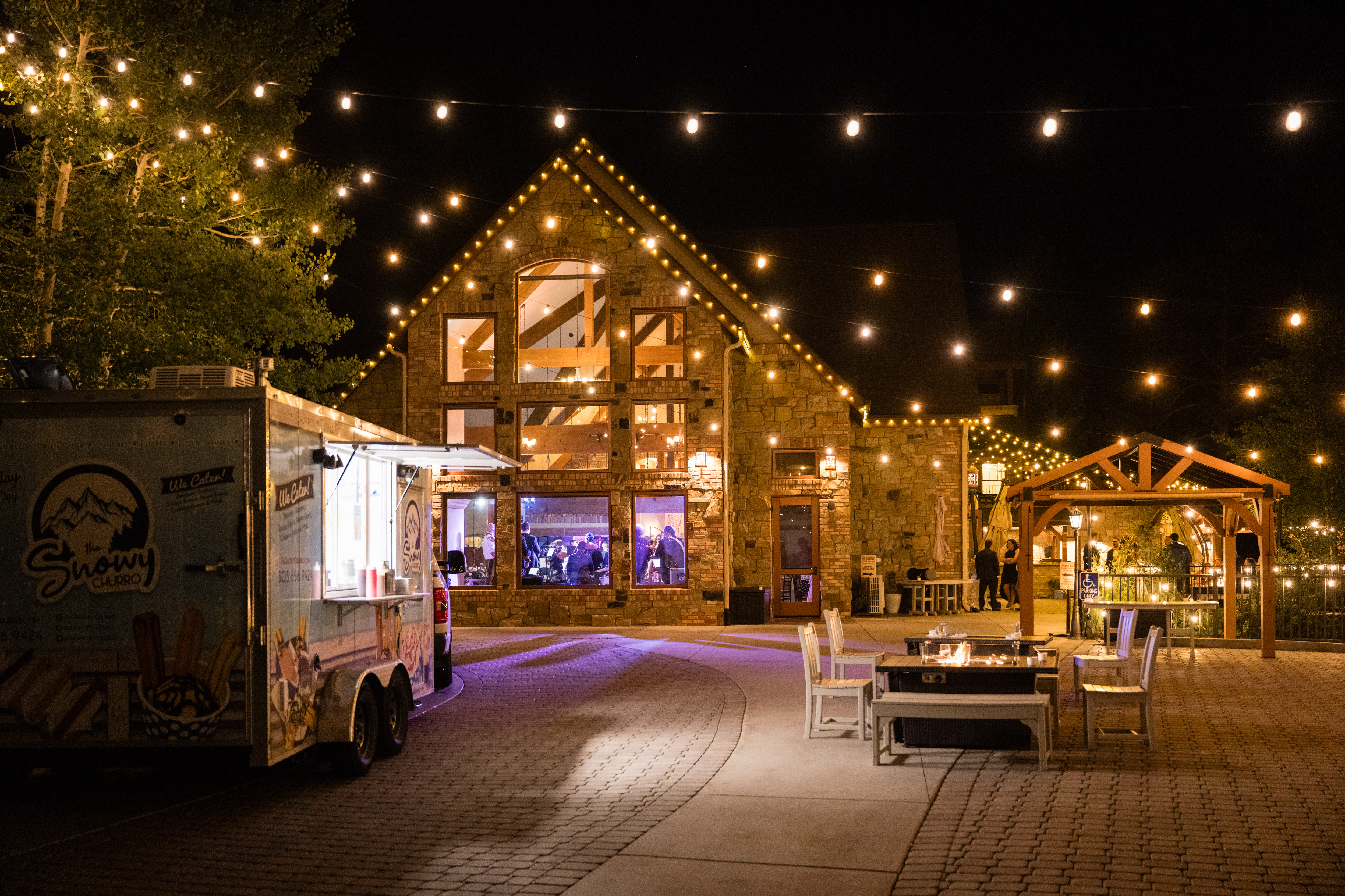 A charming food truck set in a beautifully lit outdoor venue.