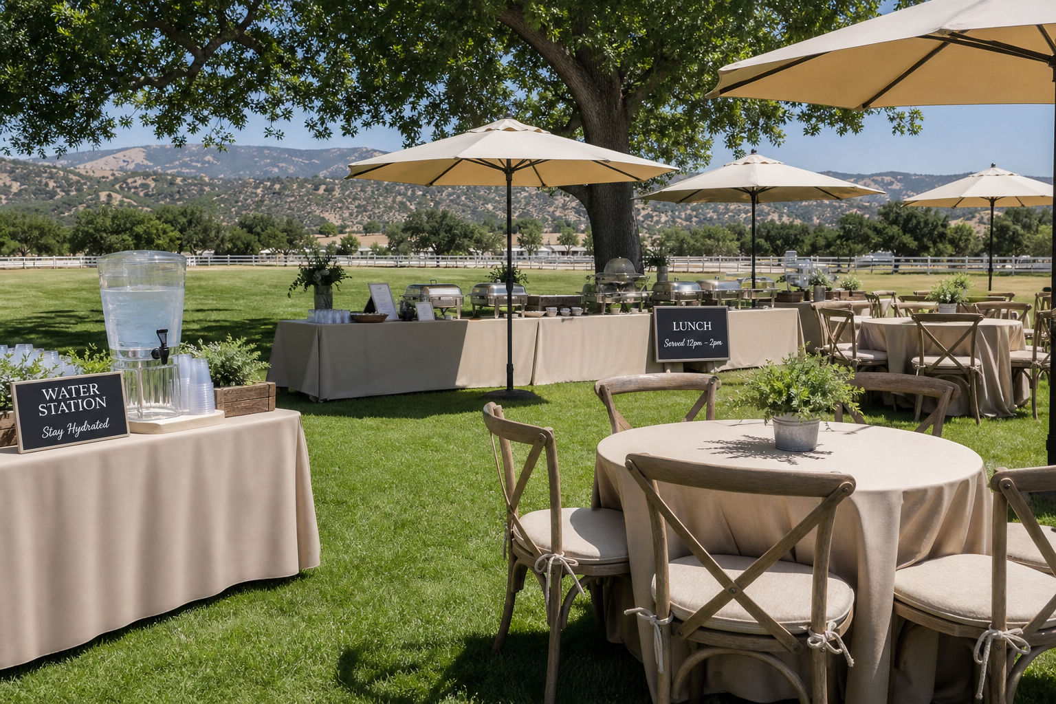 Shaded midday catered event setup with beverage station and comfortable seating